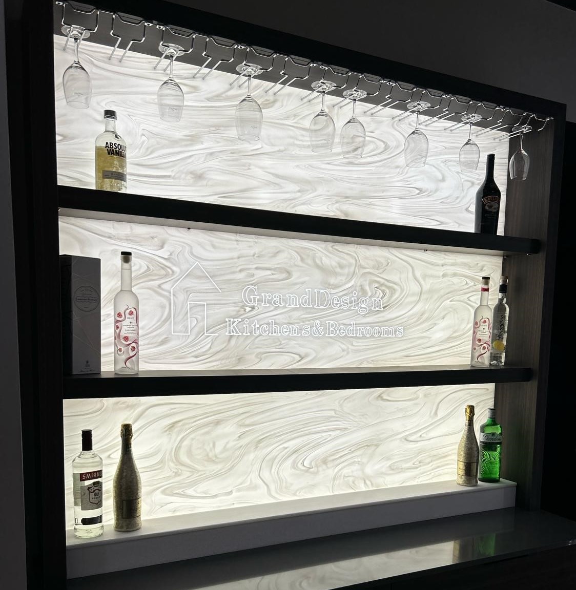 display bar shelves with alcohol bottles and wine glasses hung upside down, designed and fitted by grand design